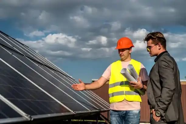 Electrician explain about solar panels to client.